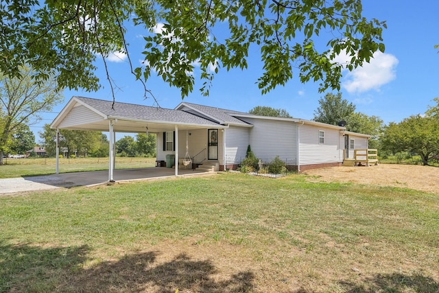 view of front of house featuring entry steps, driveway, a front lawn, and an attached carport