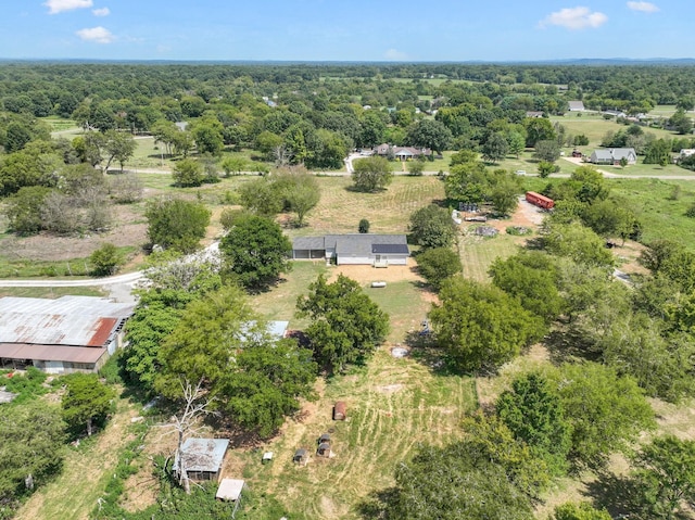 drone / aerial view featuring a wooded view