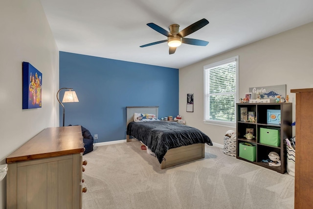 carpeted bedroom with ceiling fan and baseboards