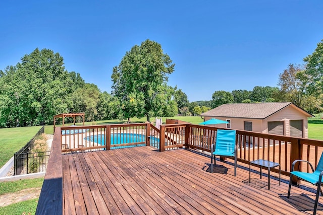 deck featuring a garage, a gazebo, a lawn, and a fenced in pool