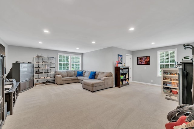 living area featuring recessed lighting, light colored carpet, and baseboards