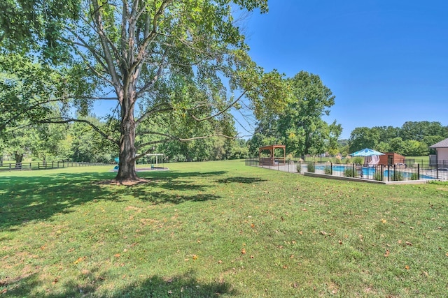 view of yard featuring a fenced in pool, fence, and a gazebo