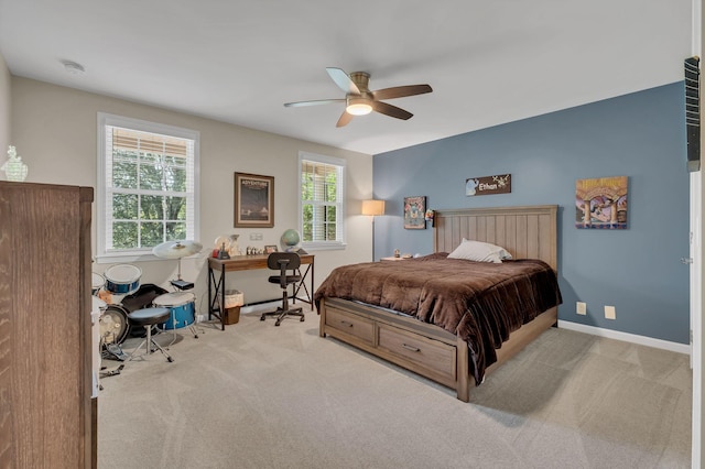 carpeted bedroom featuring a ceiling fan and baseboards