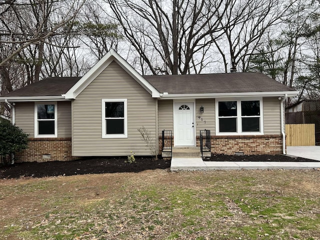 ranch-style home featuring brick siding, crawl space, and fence