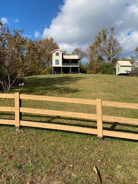 exterior space featuring fence and a lawn