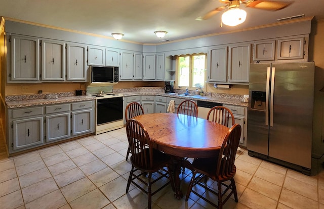 kitchen with stainless steel appliances, light tile patterned flooring, visible vents, and gray cabinetry