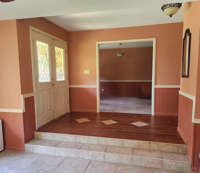 entryway with wainscoting and wood finished floors