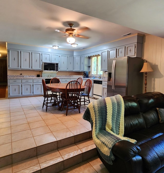 dining room featuring light tile patterned floors, ceiling fan, and visible vents