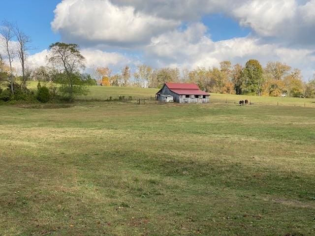 view of yard featuring an outbuilding and a rural view