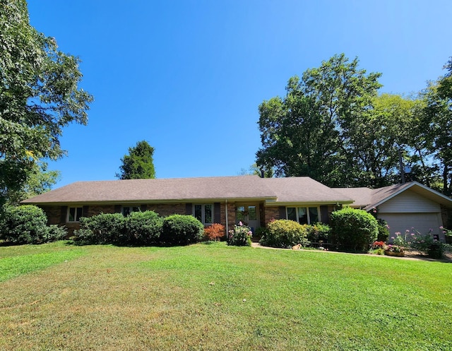 ranch-style house with an attached garage, brick siding, and a front yard