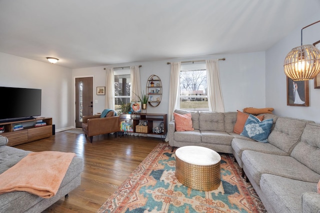 living room with an inviting chandelier and wood finished floors