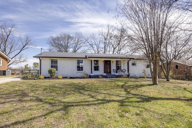 single story home featuring a front lawn, cooling unit, fence, and brick siding