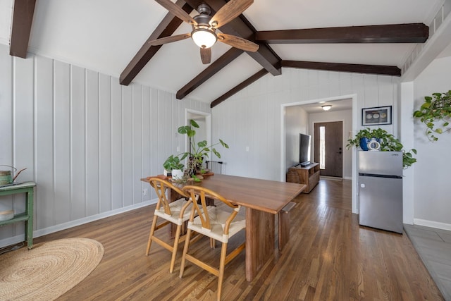 dining space featuring ceiling fan, baseboards, wood finished floors, and vaulted ceiling with beams