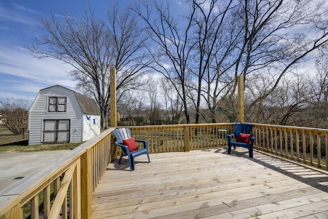 wooden terrace featuring an outdoor structure