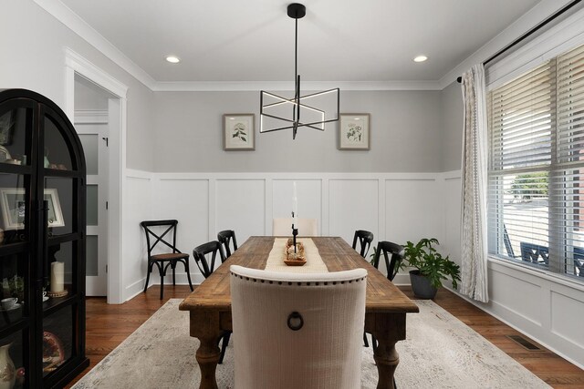 8858 Silver Maple Dr, Ooltewah, TN 37363 - dining area with a decorative wall, a notable chandelier, dark wood-style flooring, visible vents, and crown molding