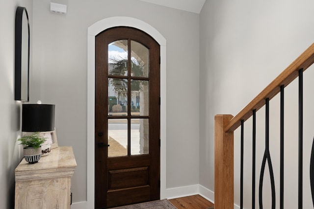 8858 Silver Maple Dr, Ooltewah, TN 37363 - entrance foyer with arched walkways, baseboards, and wood finished floors