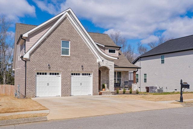 view of front facade with driveway, roof with shingles, and brick siding