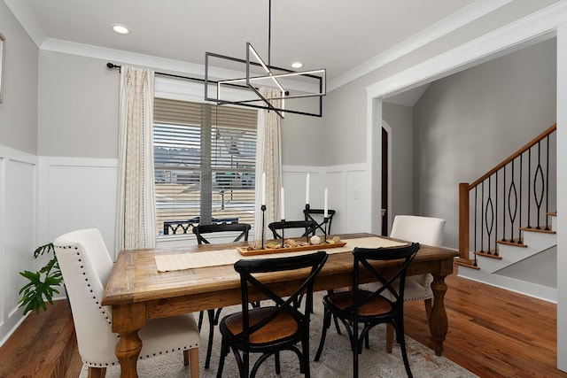8858 Silver Maple Dr, Ooltewah, TN 37363 - dining area featuring stairway, ornamental molding, wood finished floors, and a wainscoted wall