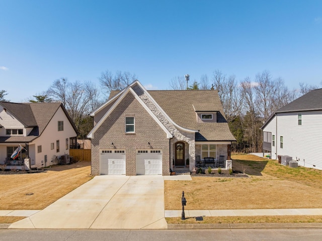 view of front facade with a garage, a front yard, concrete driveway, and brick siding