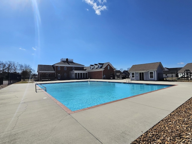 8858 Silver Maple Dr, Ooltewah, TN 37363 - community pool with an outbuilding, a patio, fence, and a residential view