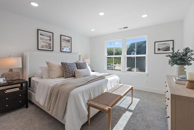 bedroom featuring light carpet, recessed lighting, visible vents, and baseboards