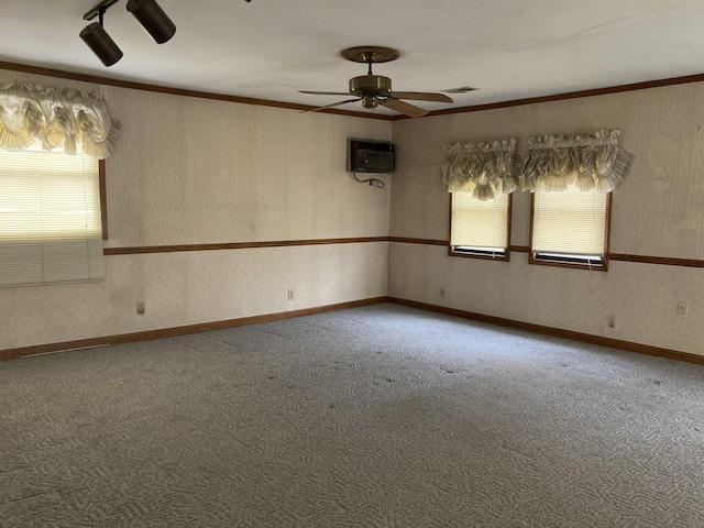 unfurnished room with ornamental molding, carpet, baseboards, and wallpapered walls