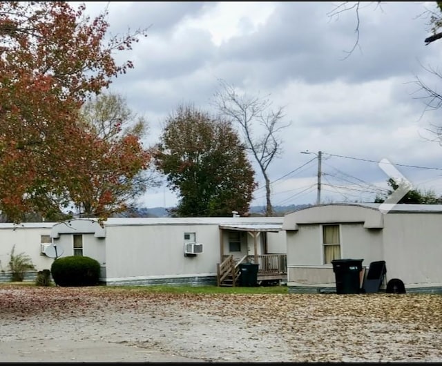 rear view of property with cooling unit