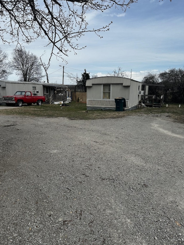 view of property exterior with gravel driveway