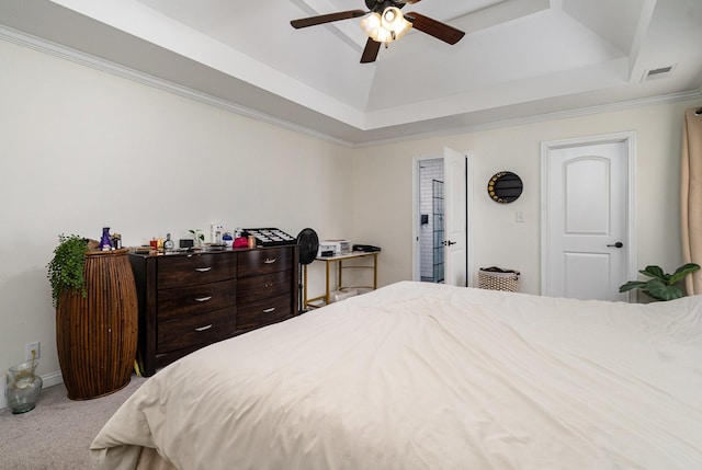 bedroom featuring a tray ceiling, carpet, visible vents, ornamental molding, and a ceiling fan