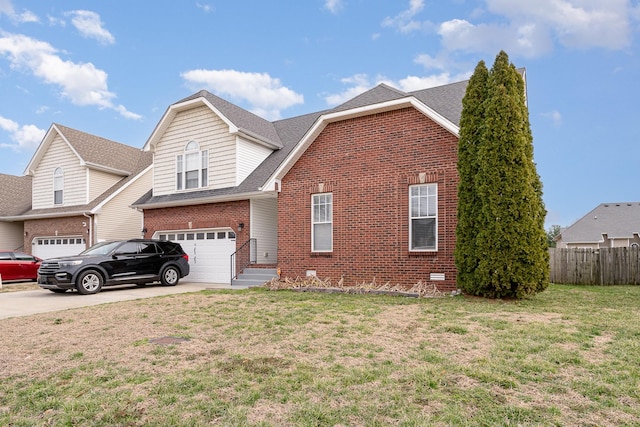 traditional home featuring driveway, roof with shingles, fence, and brick siding