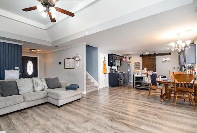 living room with baseboards, stairway, crown molding, light wood-style floors, and ceiling fan with notable chandelier