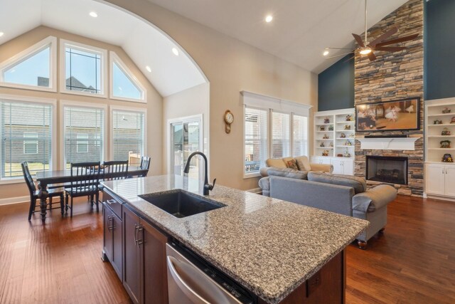 kitchen featuring dishwasher, a wealth of natural light, a sink, and dark wood finished floors