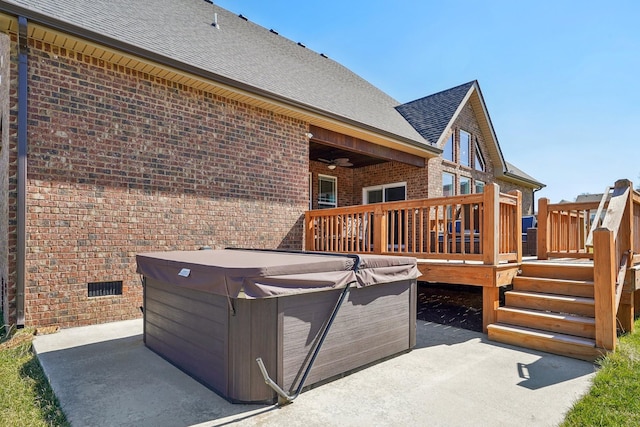 wooden deck featuring a patio area and a hot tub