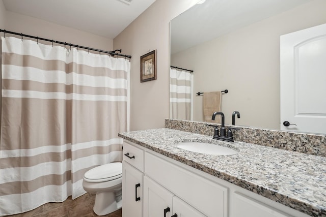 full bathroom with vanity, toilet, and tile patterned floors