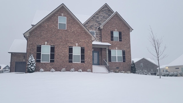 traditional home with crawl space, a garage, and brick siding