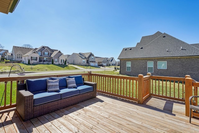 wooden terrace with a residential view, outdoor lounge area, and a lawn