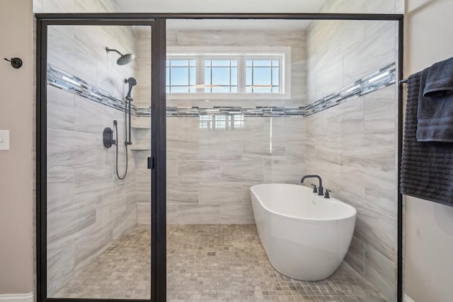 full bathroom with a soaking tub and a shower stall