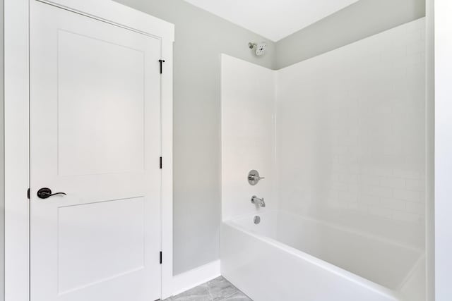 full bath featuring shower / bath combination and baseboards