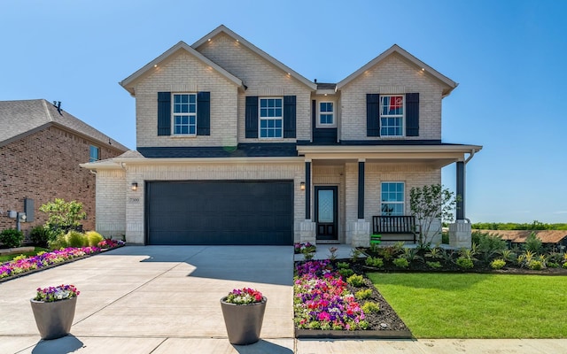 craftsman-style home with driveway, covered porch, an attached garage, a front yard, and brick siding