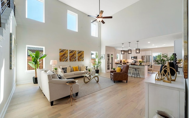 living area featuring recessed lighting, baseboards, light wood-type flooring, and ceiling fan