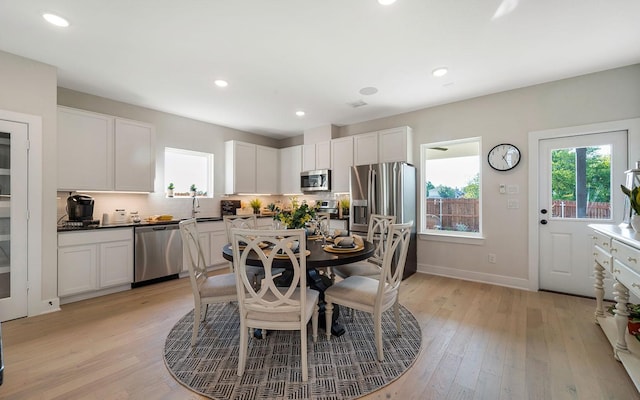 dining space with recessed lighting, baseboards, and light wood-style floors