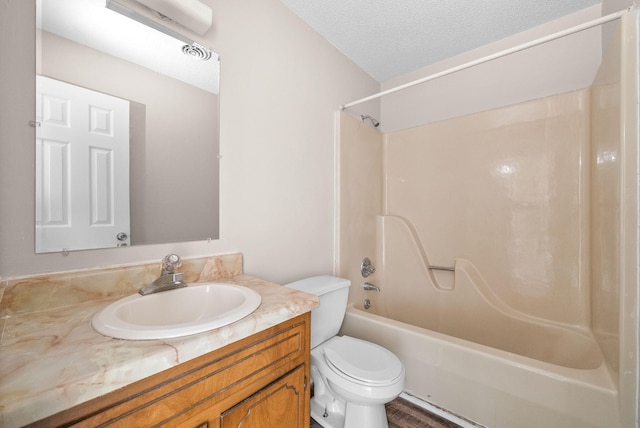 full bathroom featuring visible vents, toilet, washtub / shower combination, a textured ceiling, and vanity