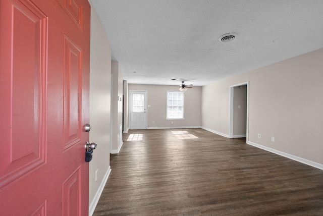 entrance foyer featuring dark wood finished floors, visible vents, a ceiling fan, a textured ceiling, and baseboards