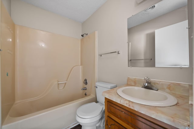 bathroom with toilet, bathtub / shower combination, a textured ceiling, and vanity