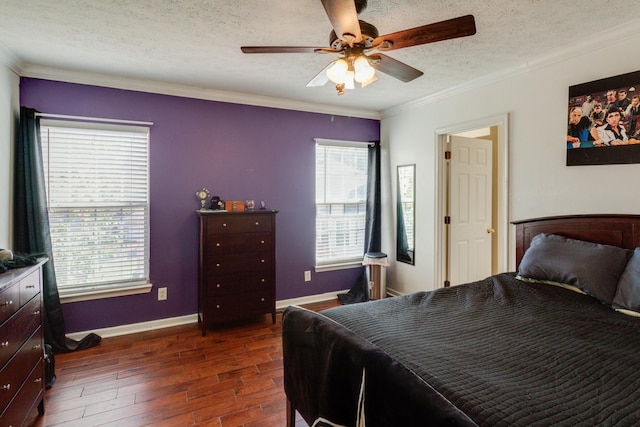 bedroom featuring ornamental molding, dark wood-style flooring, a textured ceiling, and baseboards