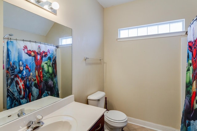 bathroom featuring toilet, vanity, baseboards, and tile patterned floors