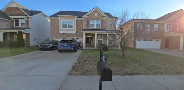 view of front of house with a garage, a front yard, and driveway