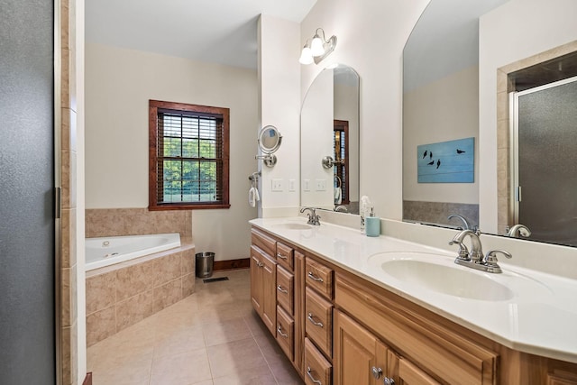 bathroom featuring double vanity, tile patterned flooring, a sink, and a shower stall