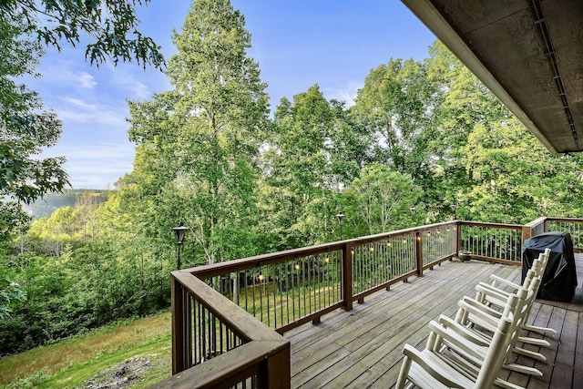 wooden terrace with a grill