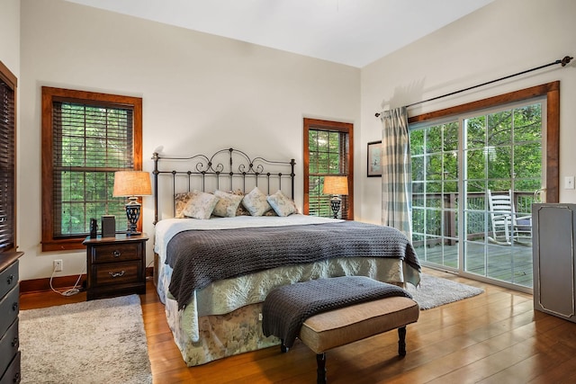 bedroom with hardwood / wood-style flooring and access to exterior